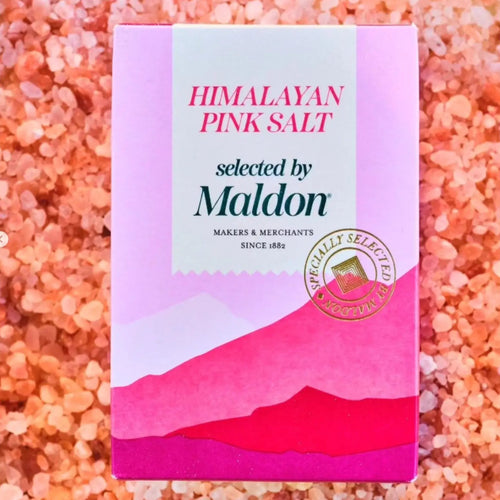 Himalayan pink salt package by Maldon on a bed of pink salt crystals